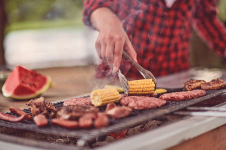 man cooking tasty food for french dinner partyの写真素材