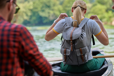 friends are canoeing in a wild riverの写真素材