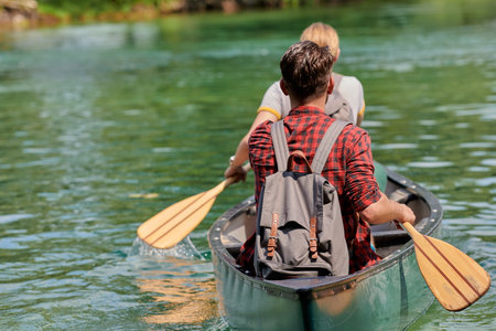 friends are canoeing in a wild riverの写真素材