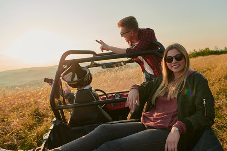 group young happy people enjoying beautiful sunny day while driving a off road buggy carの写真素材