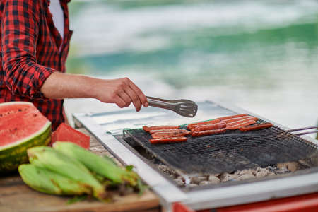 man cooking tasty food for french dinner partyの写真素材