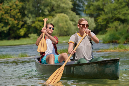 friends are canoeing in a wild riverの写真素材