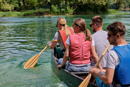 Group adventurous explorer friends are canoeing in a wild river