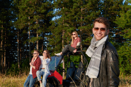 group young happy people enjoying beautiful sunny day while driving a off road buggy carの写真素材