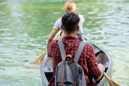 friends are canoeing in a wild riverの写真素材