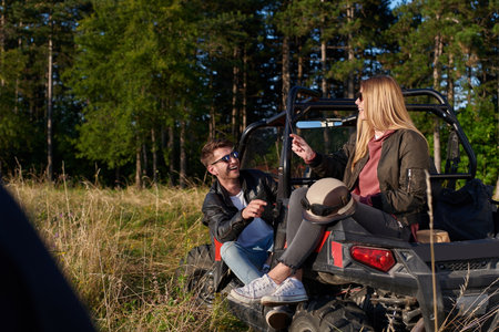 couple enjoying beautiful sunny day while driving a off road buggyの写真素材