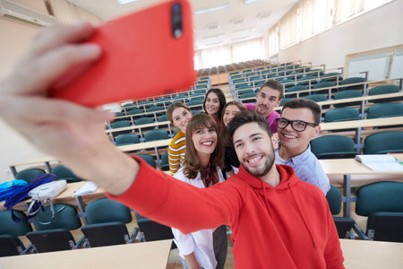Group of multiethnic teenagers taking a selfie in school