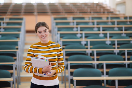 famale student using pen and notebookの写真素材