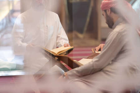 muslim people in mosque reading quran togetherの写真素材