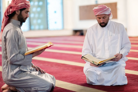 two muslim people in mosque reading quran together concept of islamic education