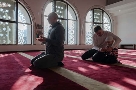 muslim prayer father and son in mosque praying andの写真素材