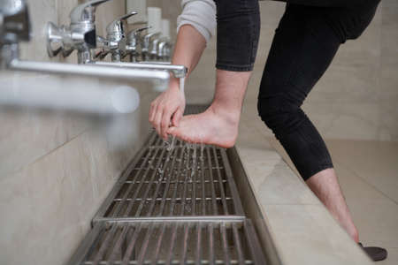 A Muslim takes ablution for prayer. Islamic religious riteの写真素材