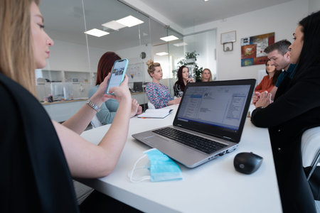 business woman as team leader on meeting checking phone messages