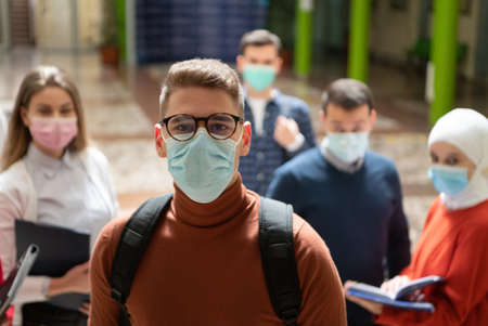 Portrait of multiethnic students group at university wearing protective face maskの写真素材