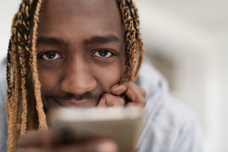 afro guy uses a cell phone and browses social media during a pandemic