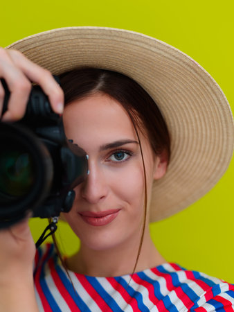Portrait of beautiful female photographer shooting close upの写真素材