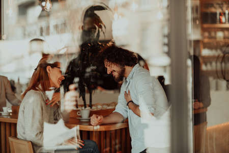 business couple sits in a cafe after a weekdayの写真素材