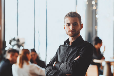 Cheerful self confident professional businessman with crossed hands portrait.