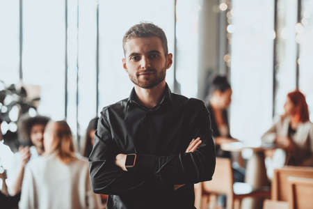 Cheerful self confident professional businessman with crossed hands portrait.の写真素材