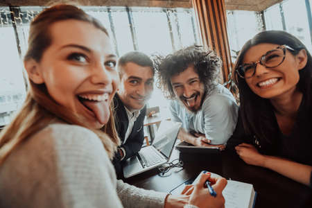 a crazy portrait of a group of entrepreneurs sitting in a modern office.の写真素材