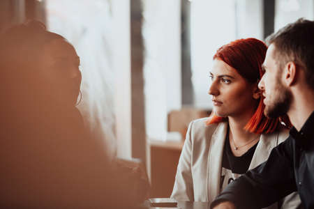a group of young entrepreneurs on a coffee break discuss the project while using modern editing tablets, a smartphone and a laptop.Business conceptの写真素材