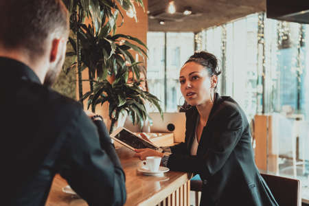 modern man and woman use modern devices, laptop, tablet and smartphone and arrange new projects for the job. Business concept .の写真素材