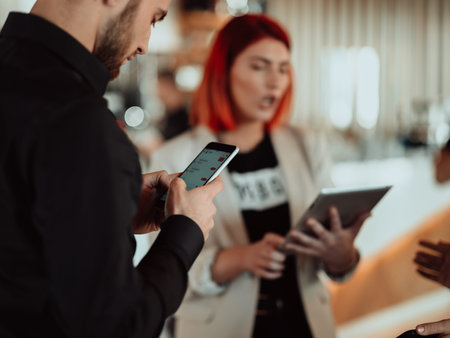 modern man and woman use modern devices, laptop, tablet and smartphone and arrange new projects for...