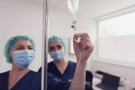 General practitioner holding intravenous drip infusion.の写真素材