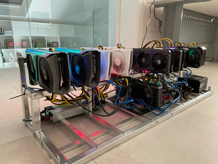 Row of bitcoin miners set up on the wired shelfs. Device for mining crypto currency. Mining...