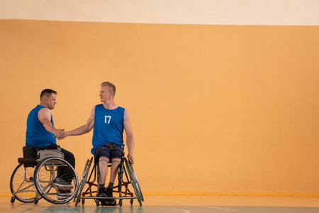 a team of war veterans in wheelchairs playing basketball, celebrating points won in a game. High...