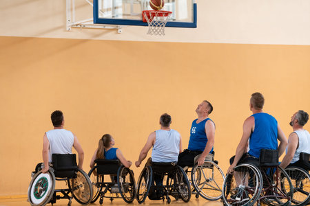 disabled war veterans in action while playing basketball on a basketball court with professional sports equipment for the disabledの写真素材