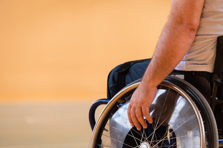 Close up photo of wheelchairs and handicapped war veterans playing basketball on the courtの写真素材