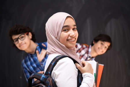 Arabic teenagers team, students group working together on laptop and tablet computer online classroom education conceptの写真素材
