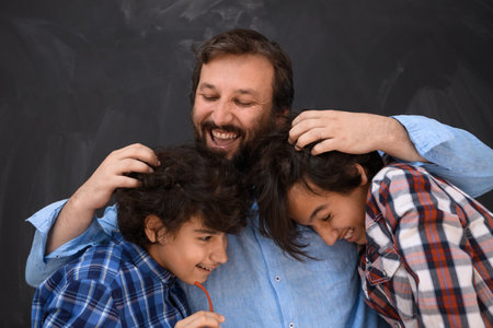 happy father hugging sons unforgetable moments of family joy in mixed race middle eastern arab familyの写真素材