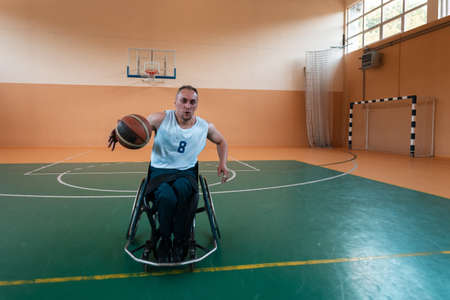 a photo of a war veteran playing basketball in a modern sports arena. The concept of sport for people with disabilitiesの写真素材