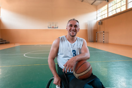 a portrait of a smiling wheelchair basketball player sitting in a wheelchair waiting for the game to...