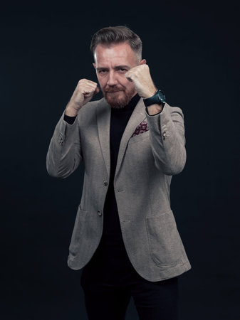 Portrait of a stylish elegant senior businessman with a beard and casual business clothes ready to...