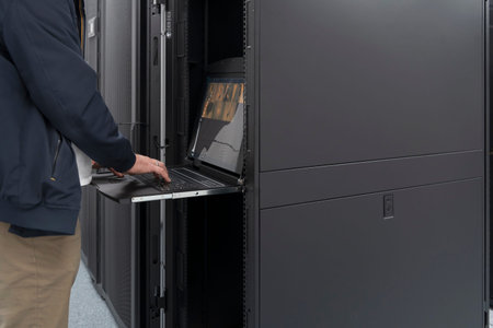 Close up on Data Center Engineer hands Using keyboard on a supercomputer Server Room Specialist...