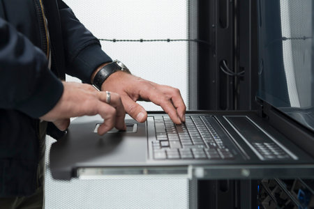 Close up on Data Center Engineer hands Using keyboard on a supercomputer Server Room Specialist...