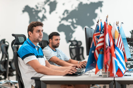 Group of Casual business man working on desktop computer in modern open plan startup office...