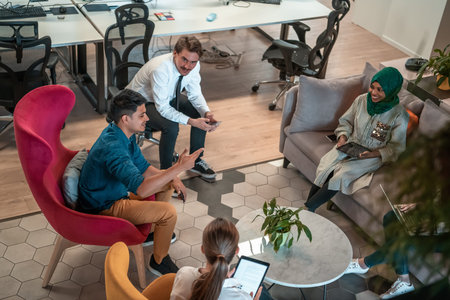 Multiethnic startup business team having brainstorming in relaxation area of modern office interior...