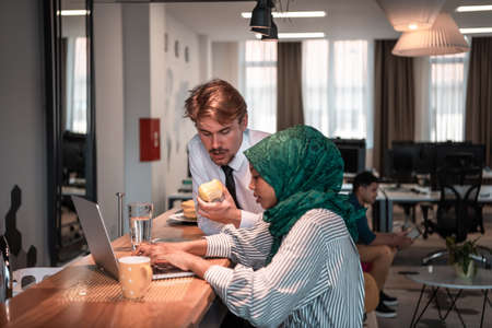 International multicultural business team.A young business man and woman sit in a modern relaxation space and talk about a new business.の写真素材