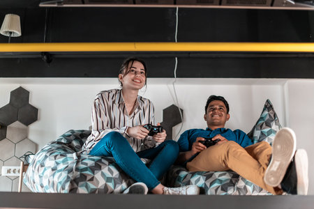 Work hard play hard. Workers Playing computer games man against woman during break in relaxation...