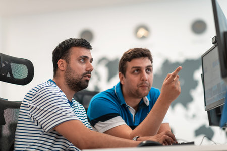 Group of Casual business man working on desktop computer in modern open plan startup office...