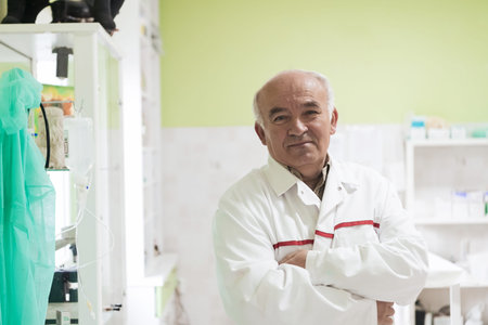Mature veterinarian man or doctor in hospital clinic smiling happy and proud.の写真素材
