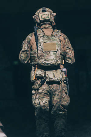 A bearded soldier in uniform of special forces in a dangerous military action in a dangerous enemy area. Selective focusの写真素材