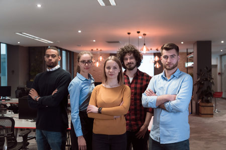 Portrait of successful creative business team looking at camera and smiling. Diverse business people...