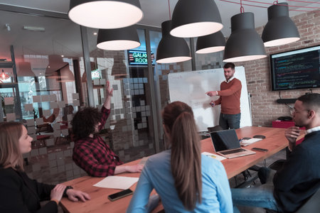 Leader give a business presentation at an office conference meeting, businessman coach mentor...