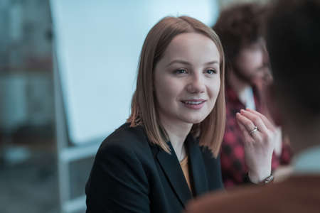 Successful team. Group of young multi-ethnic business people working and communicating together in creative office. Selective focusの写真素材