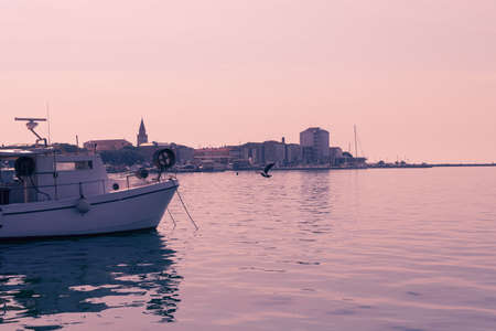 A photograph of a ship and a luxury yacht anchored in port. Beautiful photo of a Mediterranean portの写真素材